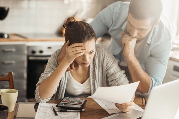 Stressed young couple doing financials in the kitchen