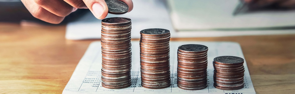 businessman saving money concept. hand holding coin strack. finance and accounting