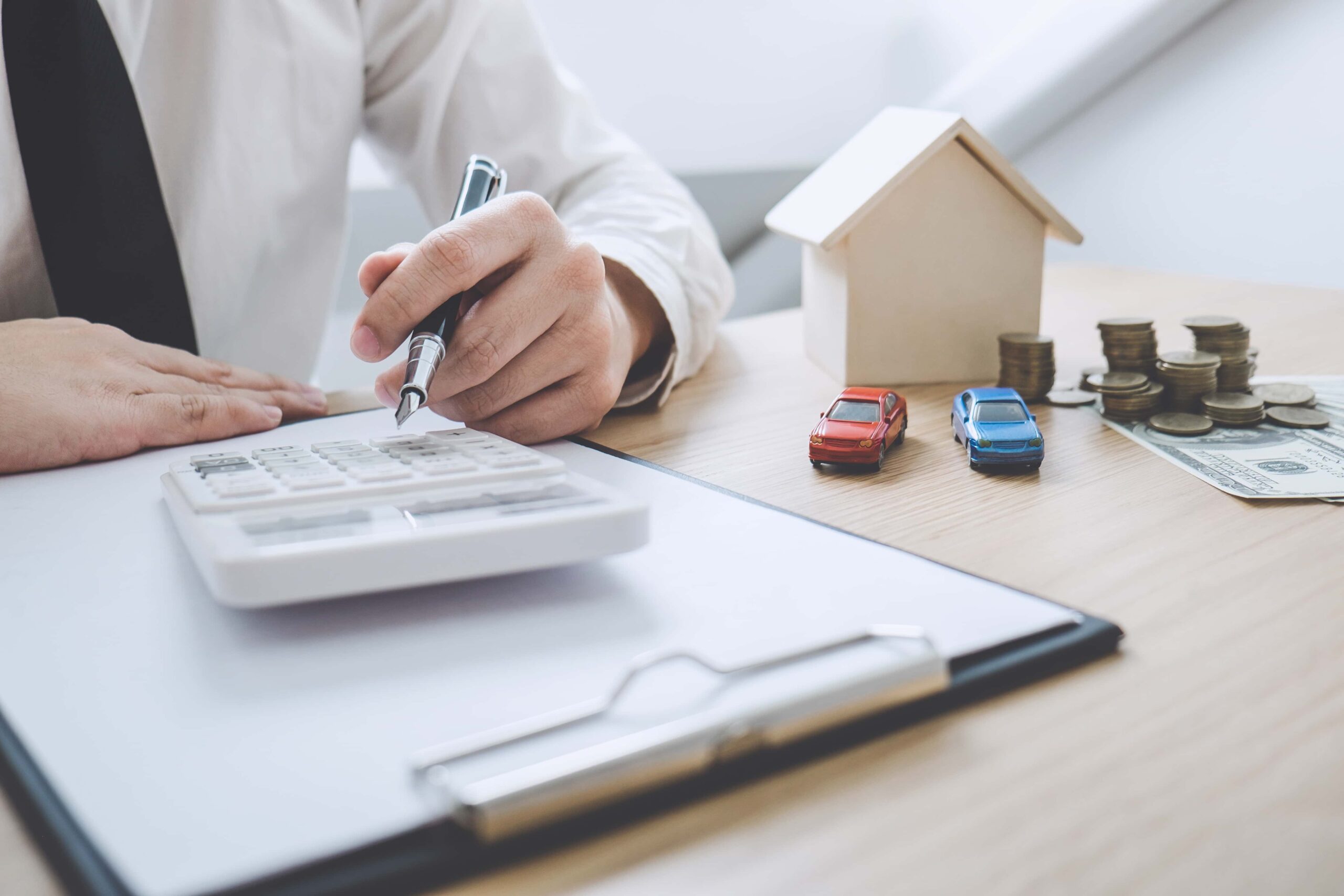 businessman working doing finances and calculation cost of real estate investment scaled