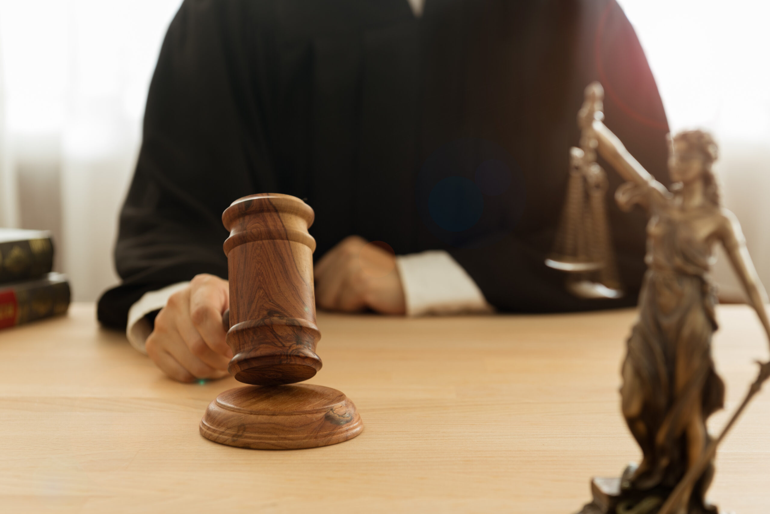 justice and law concept. Male judge take judge hammer and judge the case in a courtroom.