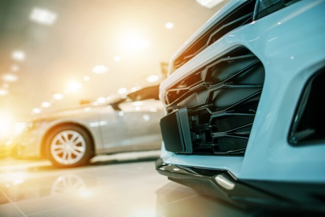 Automotive Car Business. Brand New Performance Vehicle on Display in the Car Dealer Showroom.